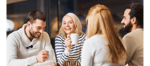 group of people laughing drinking coffee